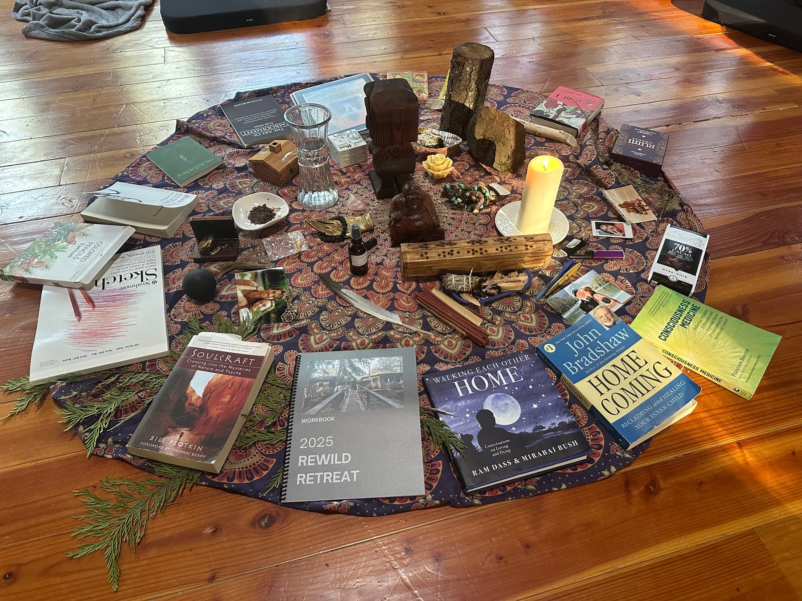 Books, a candle and keepsakes laid out on a patterned cloth